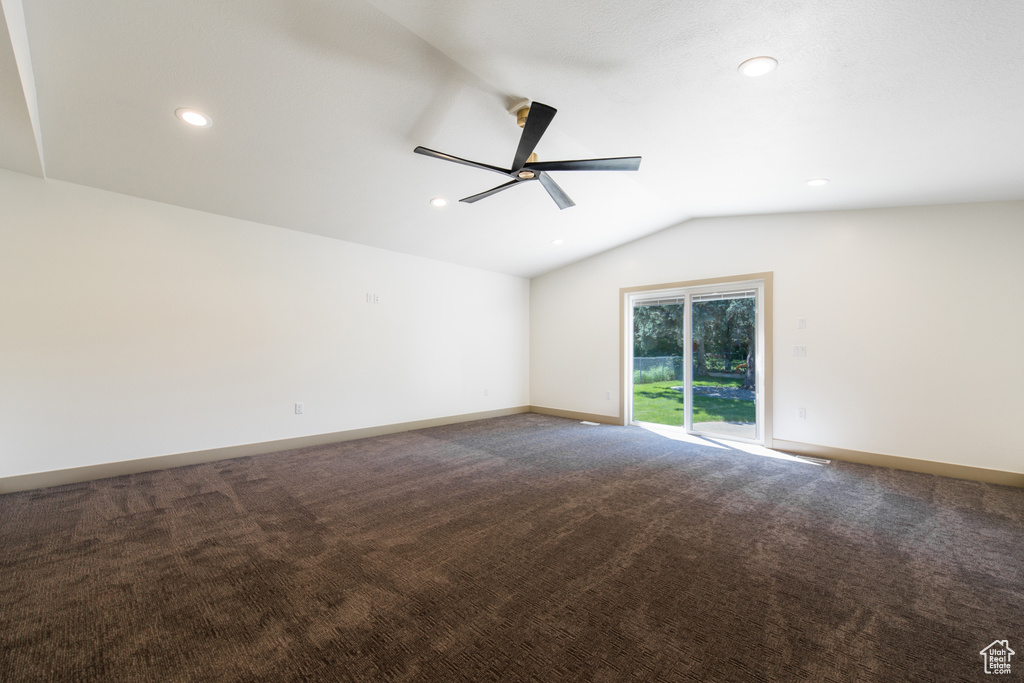 Carpeted empty room featuring a ceiling fan, vaulted ceiling, recessed lighting, and baseboards