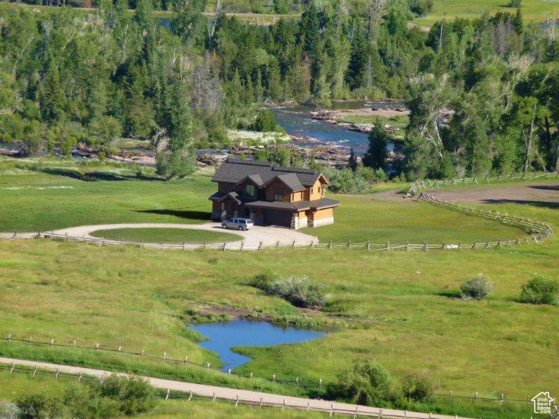 View of home\\\\\\\'s community featuring a water view and a wooded view