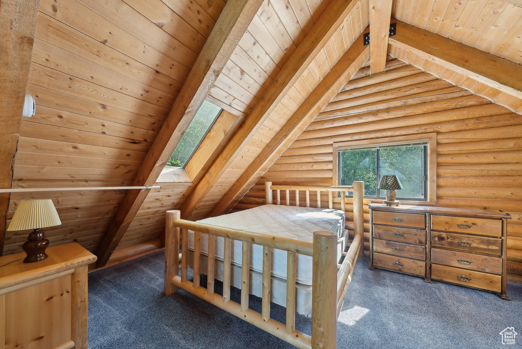 Carpeted bedroom with rustic walls and wood ceiling