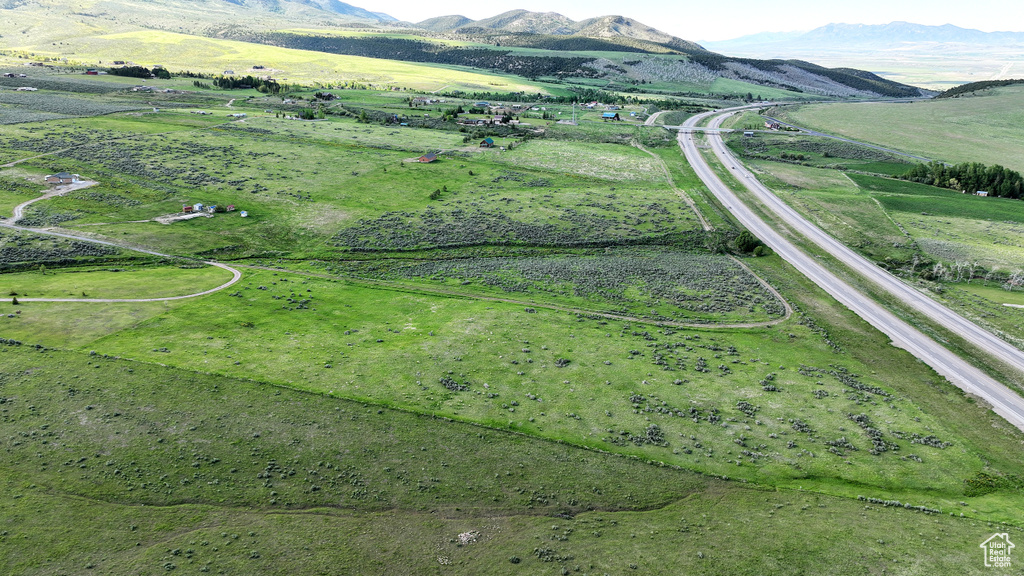 Aerial overview of property's location with a mountain backdrop and rural landscape