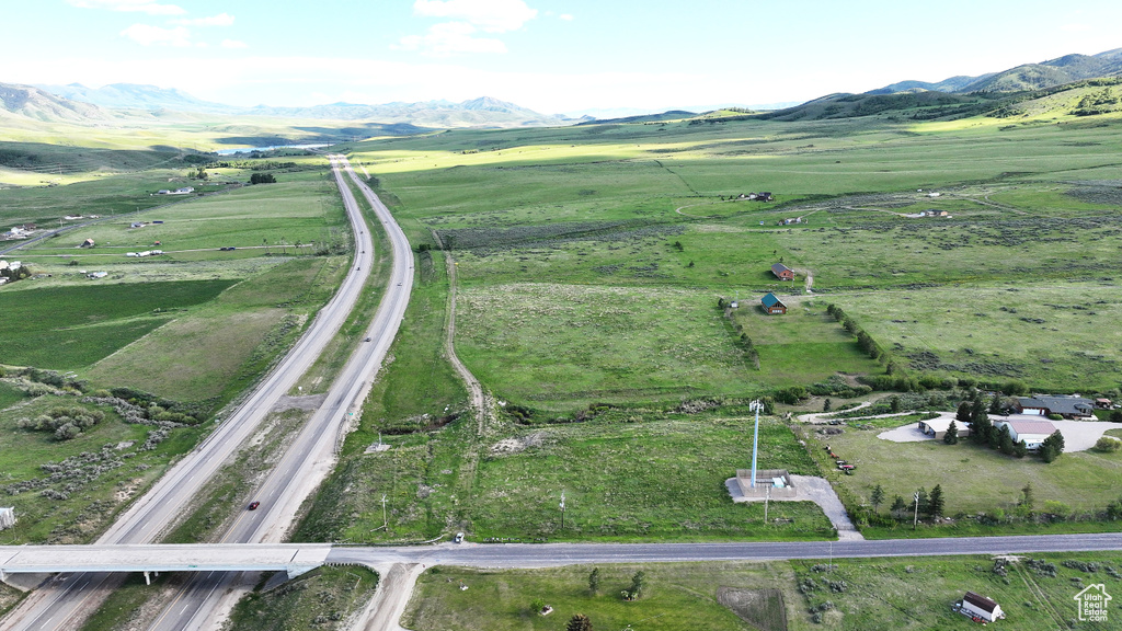 Aerial view of property's location featuring rural landscape and a mountainous background
