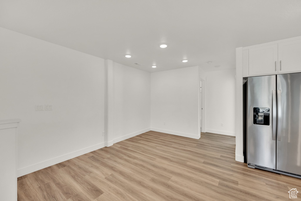 Empty room featuring recessed lighting, light wood finished floors, and baseboards