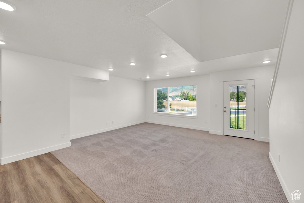 Spare room with recessed lighting, baseboards, and light carpet