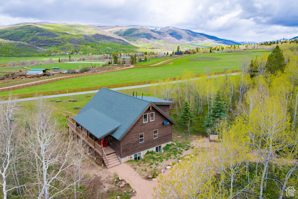 Aerial view of sparsely populated area with a mountainous background and agricultural land