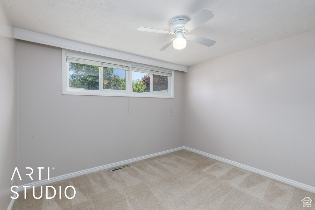 Unfurnished room with carpet flooring, ceiling fan, and baseboards