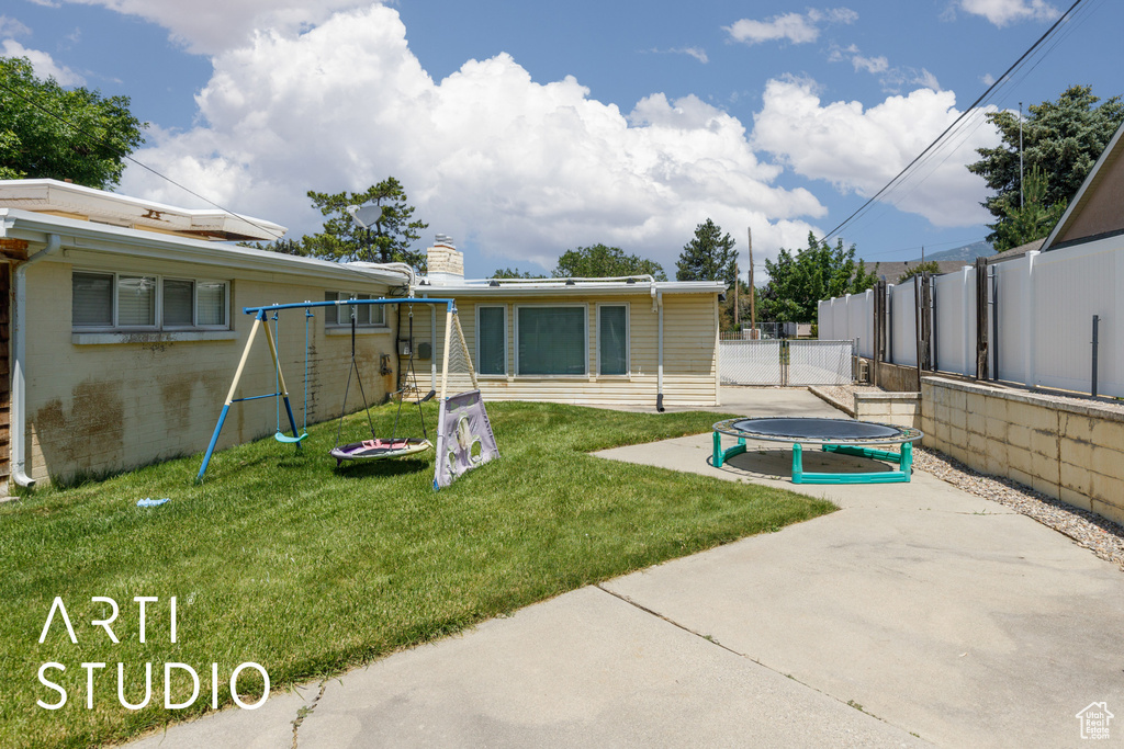 View of yard with a patio and a trampoline