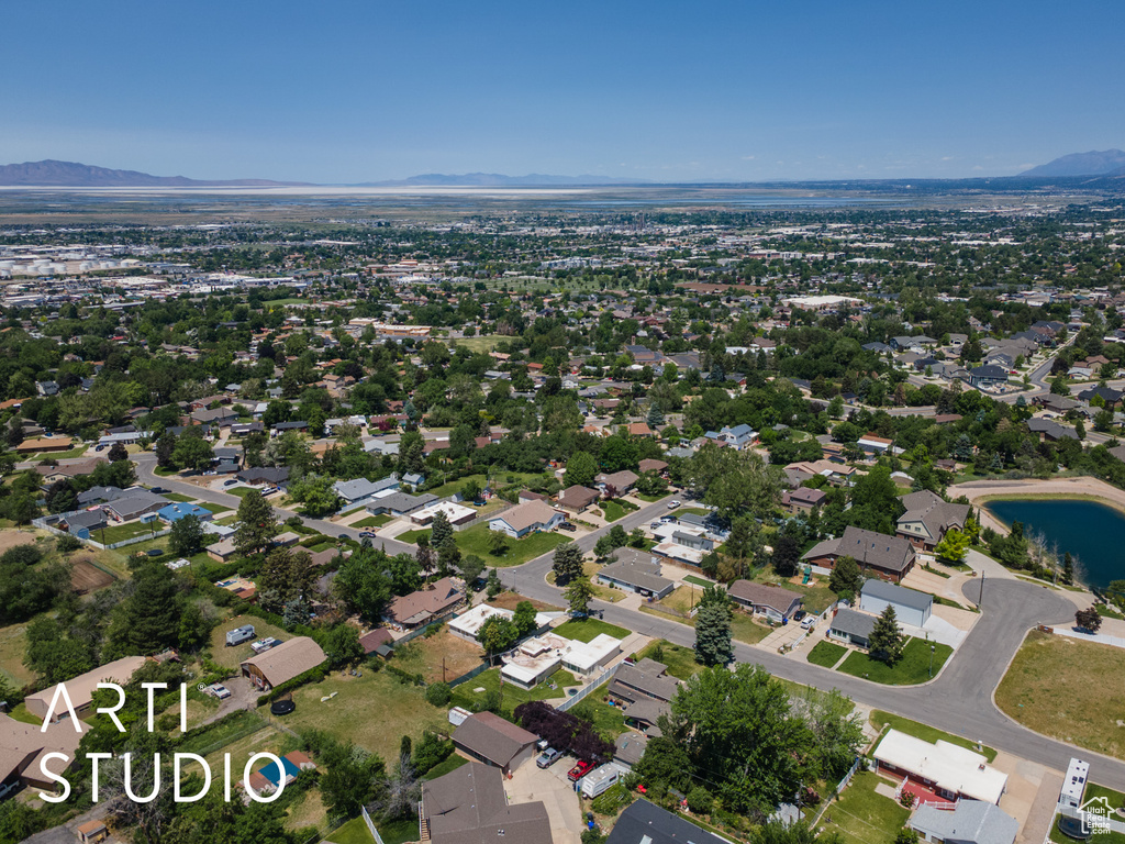 Aerial view of property and surrounding area featuring mountains