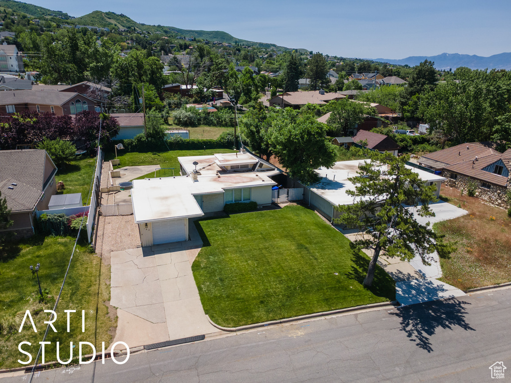 Aerial perspective of suburban area featuring a mountain backdrop