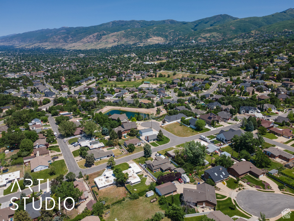 Aerial overview of property\'s location featuring a mountainous background and nearby suburban area