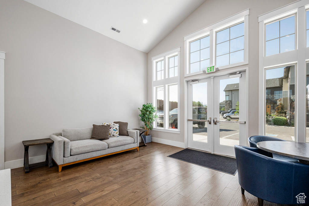 Living area featuring high vaulted ceiling, french doors, wood finished floors, baseboards, and recessed lighting