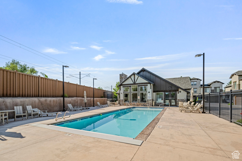 Community pool with a patio