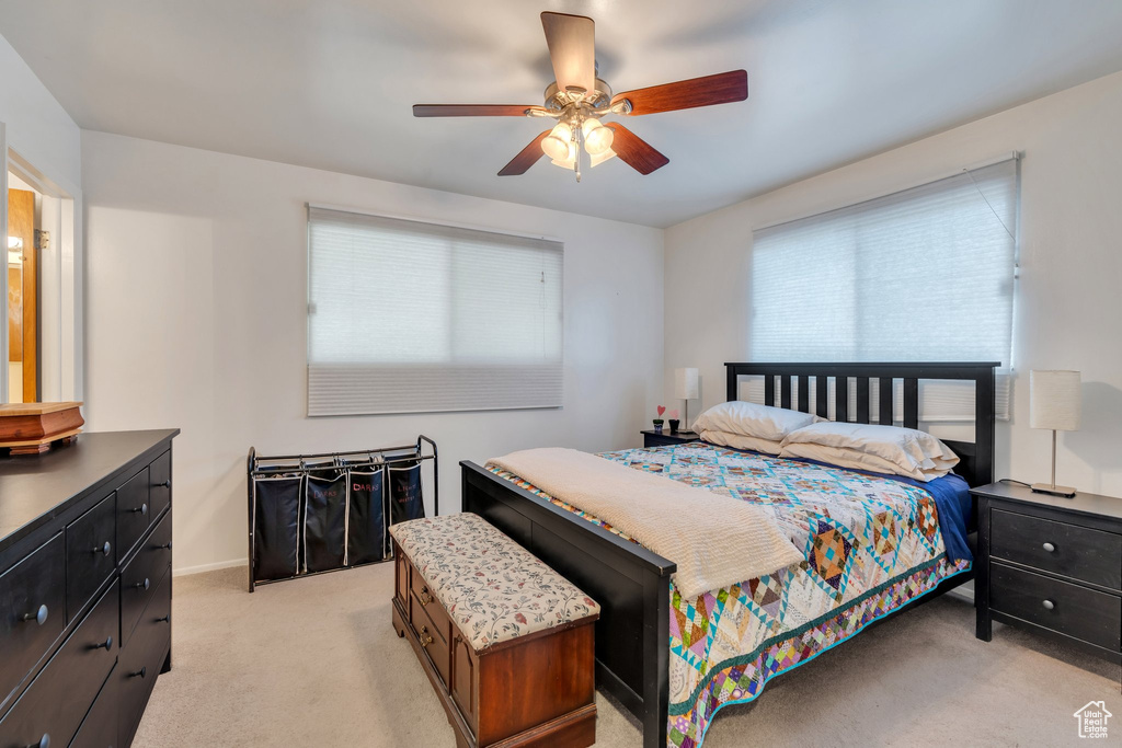 Bedroom featuring light colored carpet and a ceiling fan