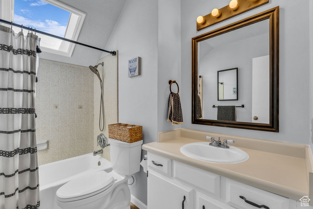 Full bathroom with toilet, shower / tub combo, and vanity
