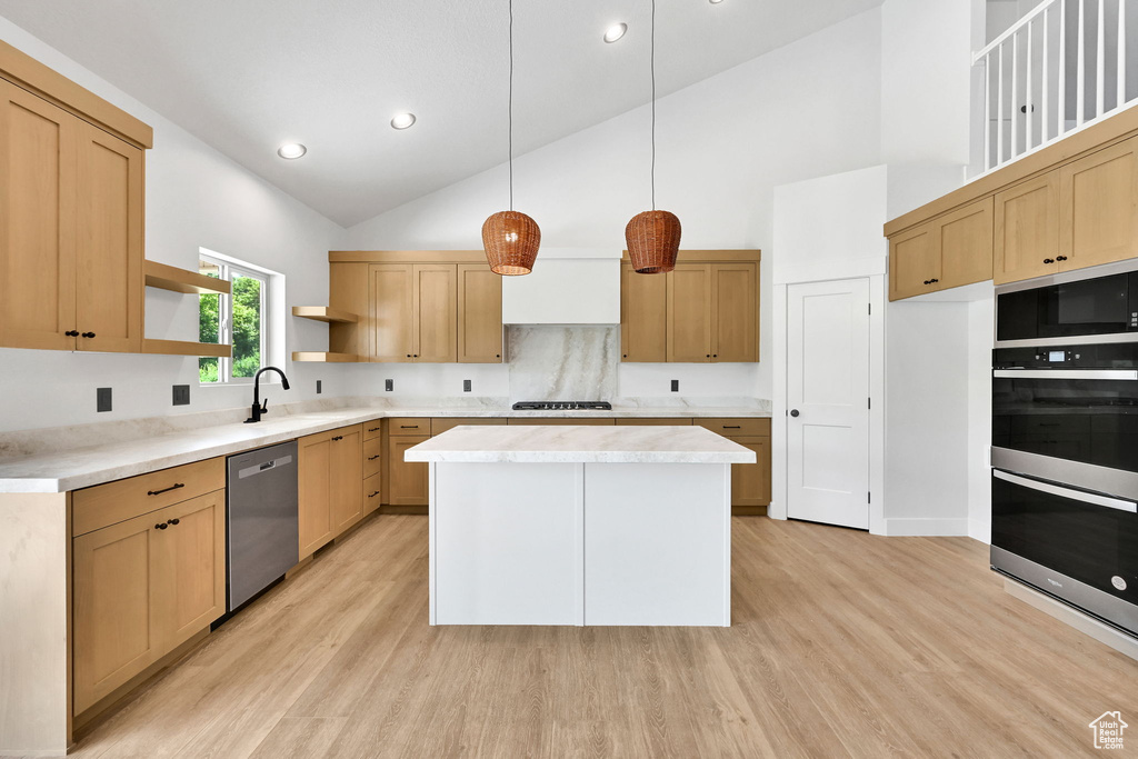 Kitchen with appliances with stainless steel finishes, open shelves, light wood-style floors, high vaulted ceiling, and light countertops