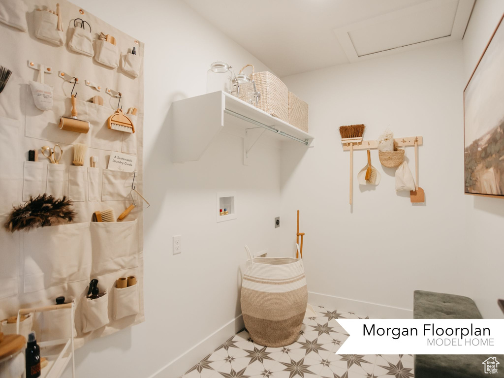 Laundry area featuring light flooring, hookup for a washing machine, electric dryer hookup, baseboards, and attic access