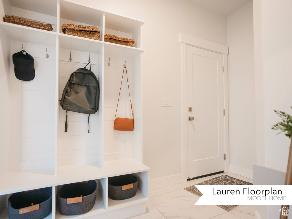 Mudroom with marble finish flooring and baseboards