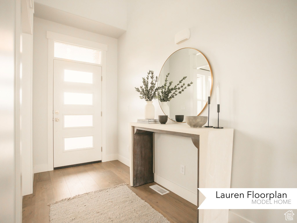 Entrance foyer with wood finished floors and baseboards