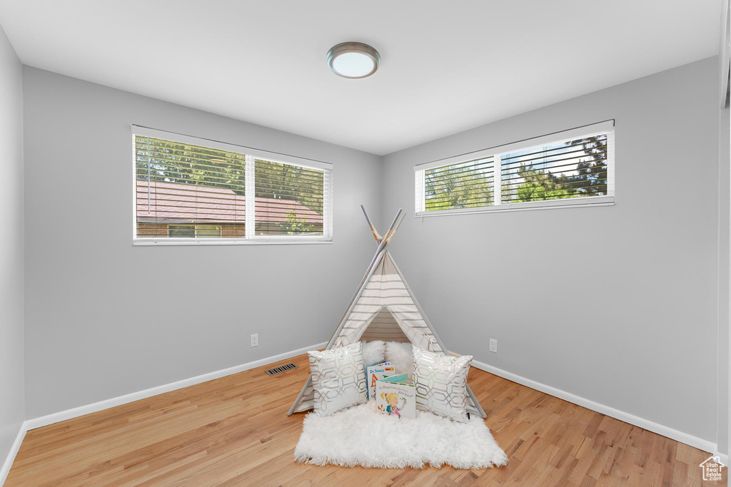 Playroom featuring wood finished floors and baseboards
