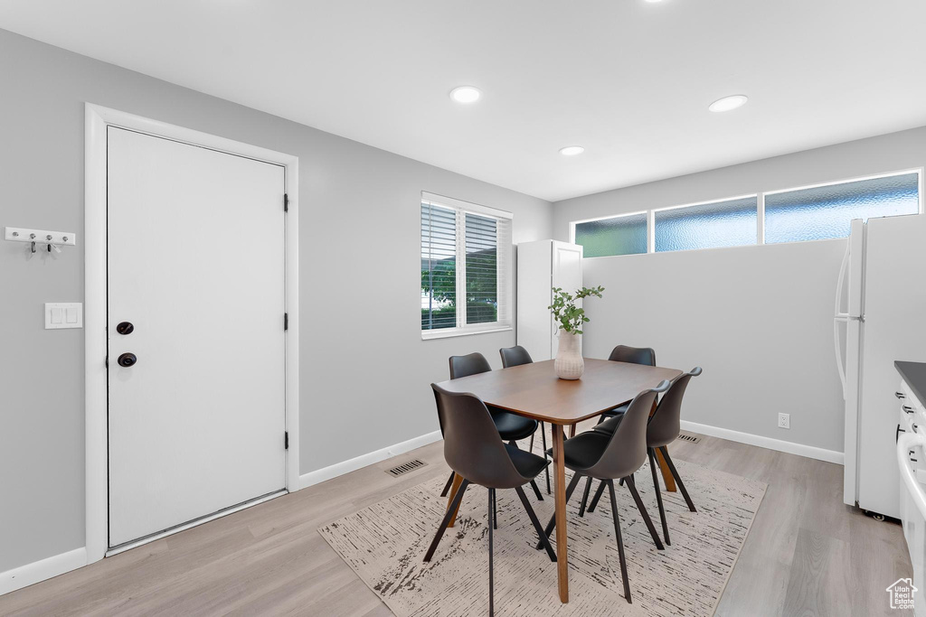 Dining space with light wood-style floors, baseboards, and recessed lighting