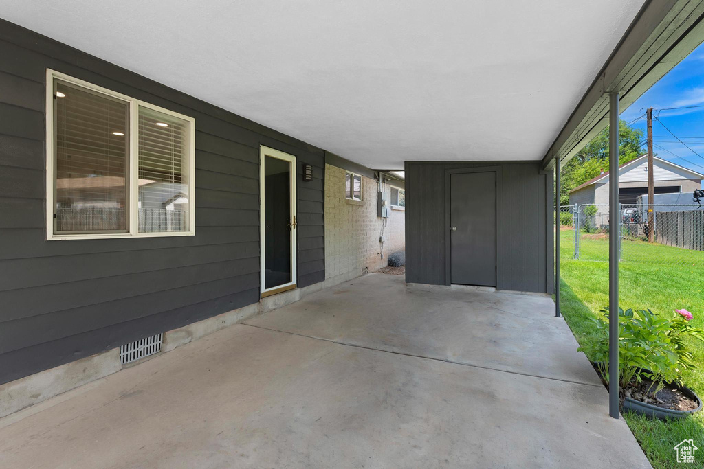 View of patio with a carport