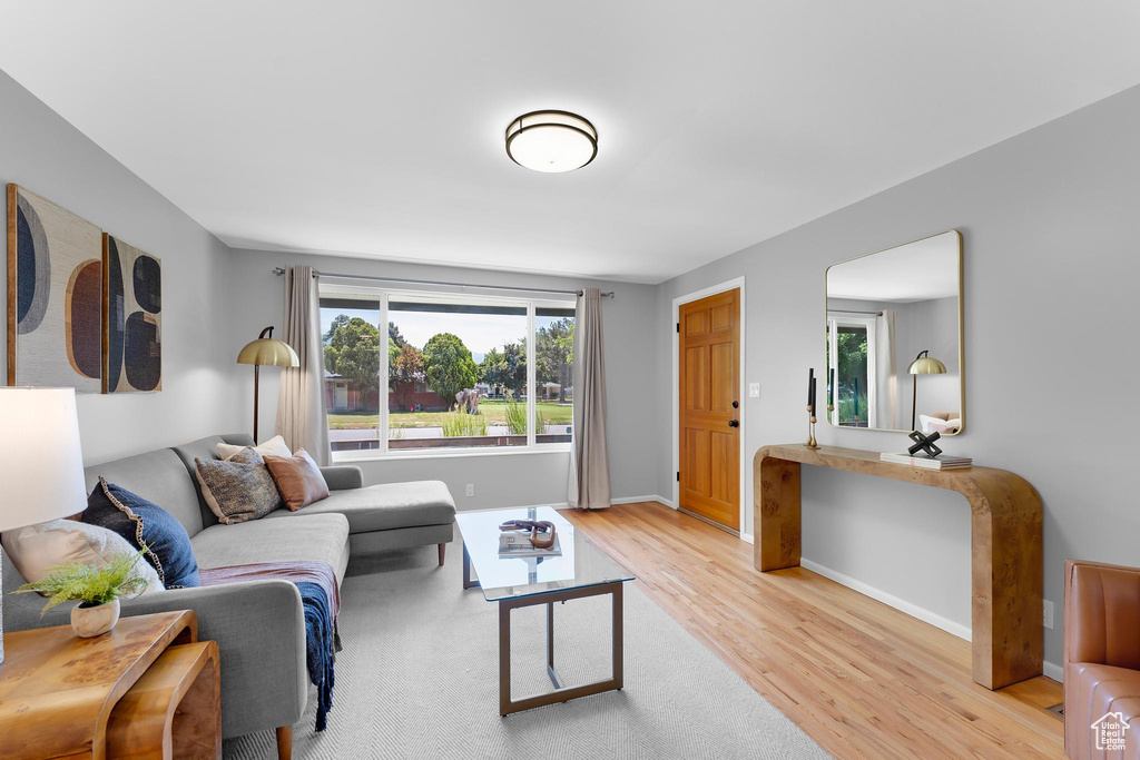 Living area with light wood-type flooring and baseboards