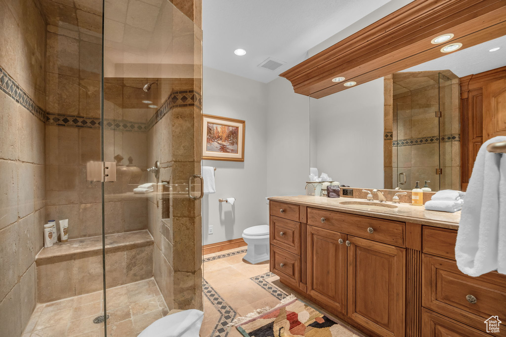 Bathroom with toilet, a stall shower, vanity, recessed lighting, and tile patterned floors