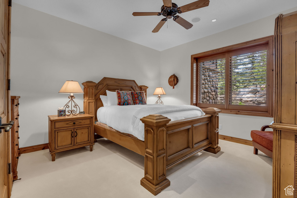 Bedroom with baseboards, recessed lighting, light carpet, and a ceiling fan