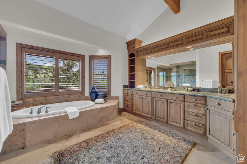 Bathroom with vanity, a garden tub, a shower stall, high vaulted ceiling, and beam ceiling