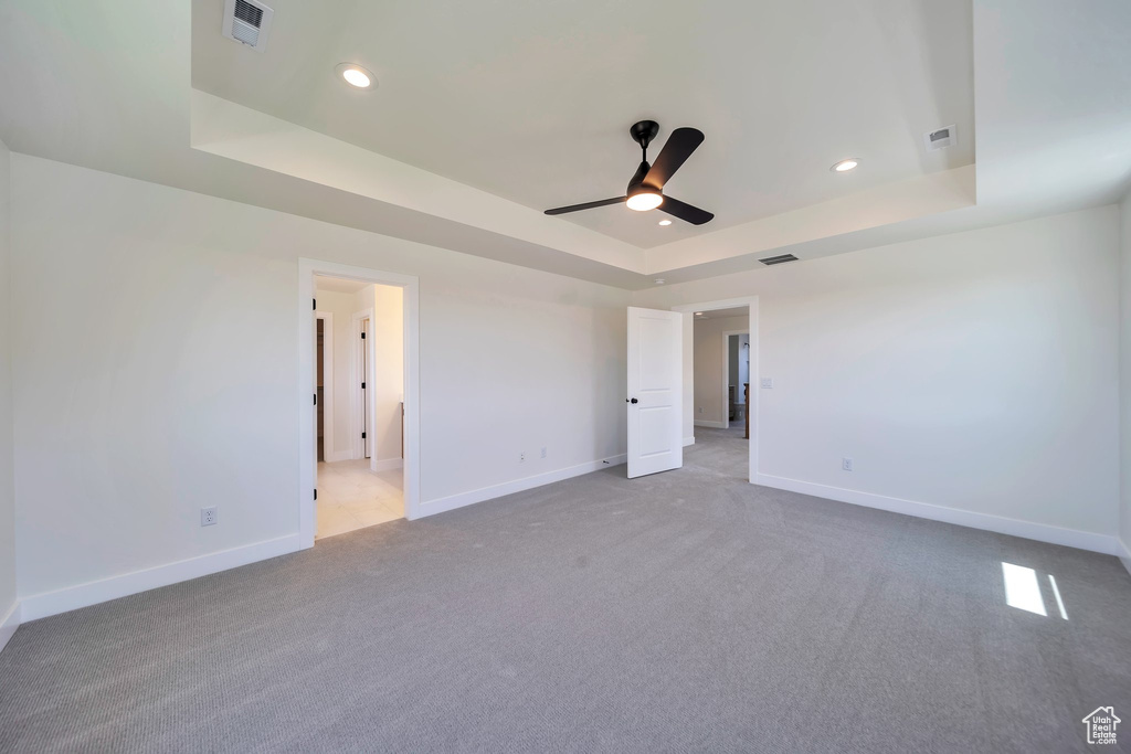Unfurnished room with a tray ceiling, baseboards, and recessed lighting