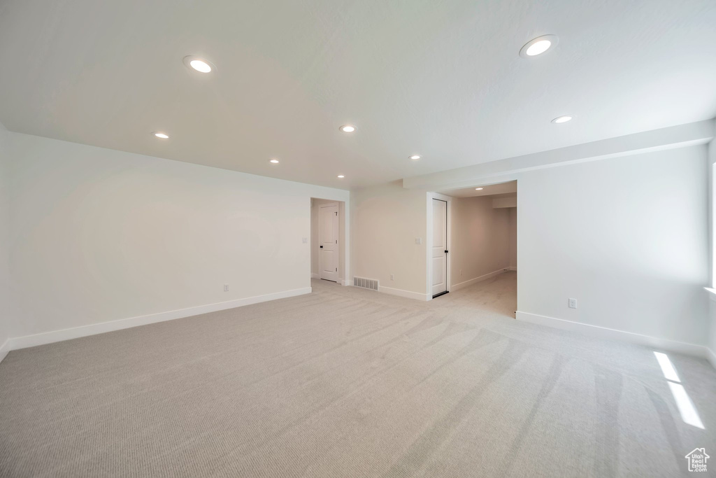 Empty room featuring recessed lighting, baseboards, and light colored carpet