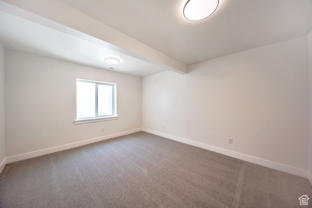 Empty room with baseboards and carpet flooring