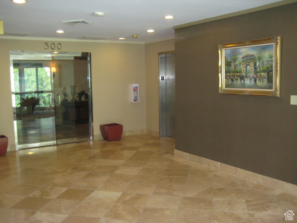 Common area with recessed lighting and ornamental molding