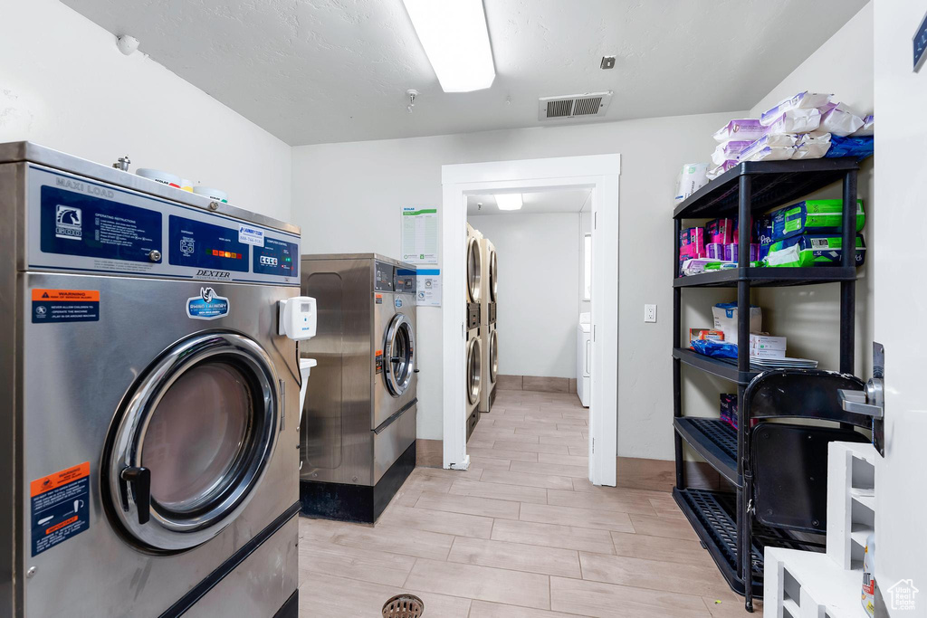 Laundry area featuring wood tiled floors and washer and clothes dryer