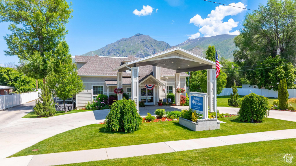 View of front of home with a mountain view and roof with shingles