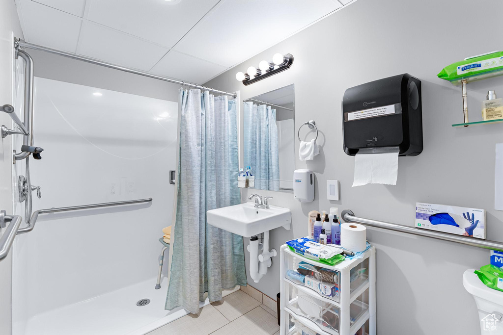 Full bathroom featuring a shower stall, tile patterned floors, and toilet