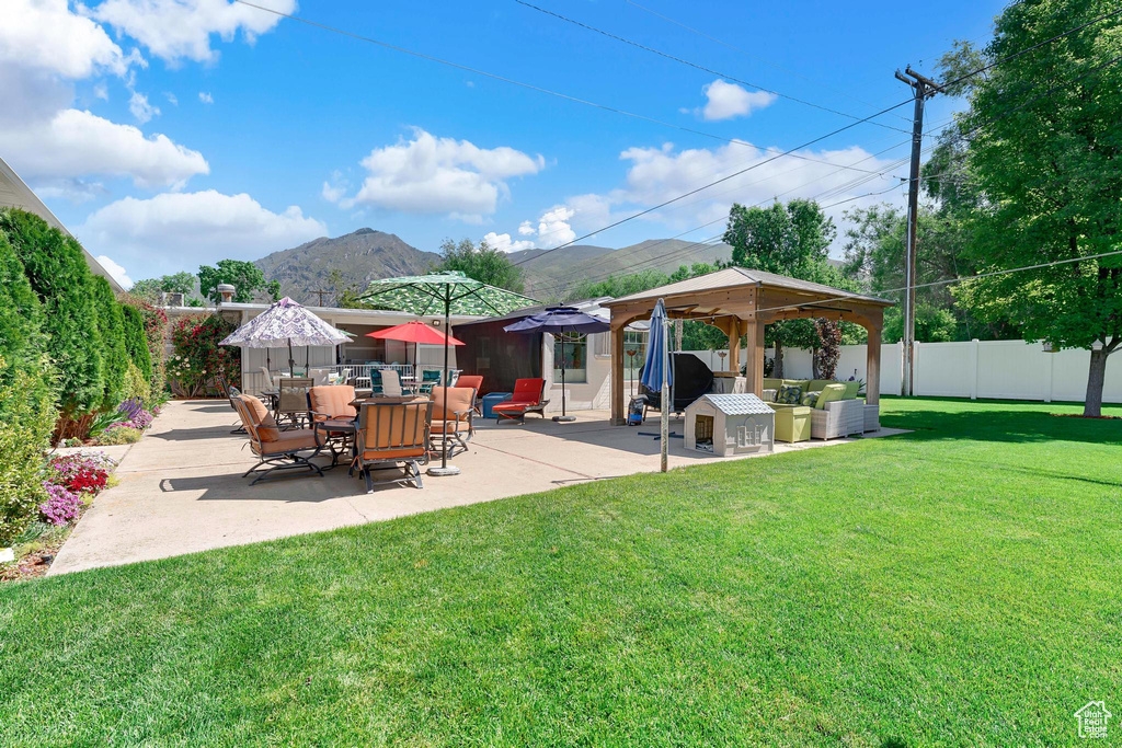 View of yard featuring a gazebo, a mountain view, and a patio area