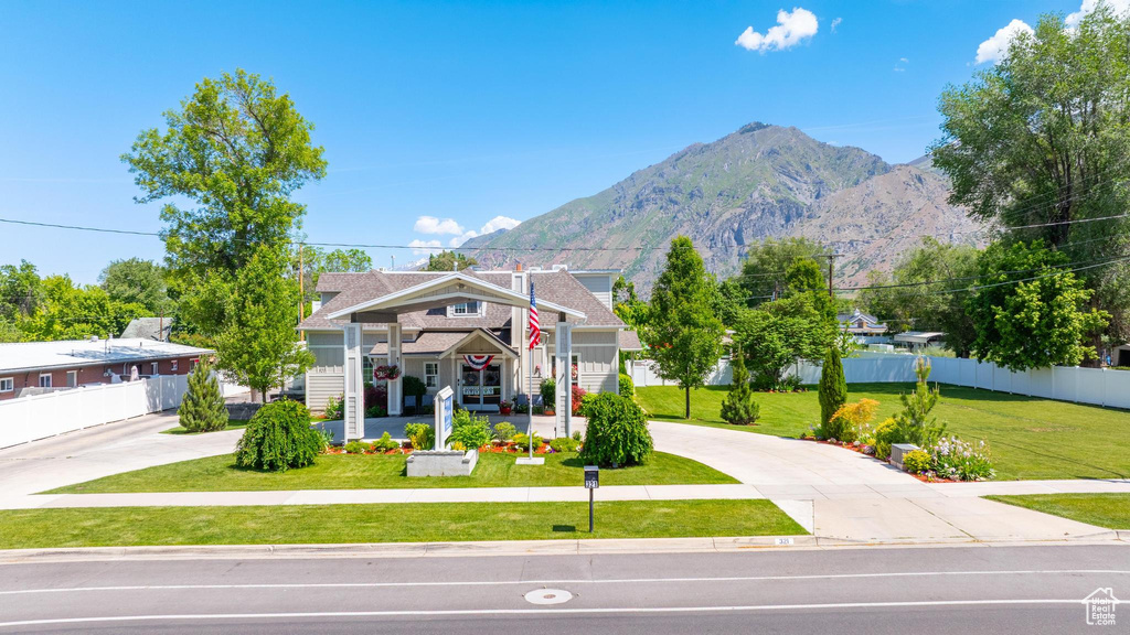 View of front facade with curved driveway and a mountain view