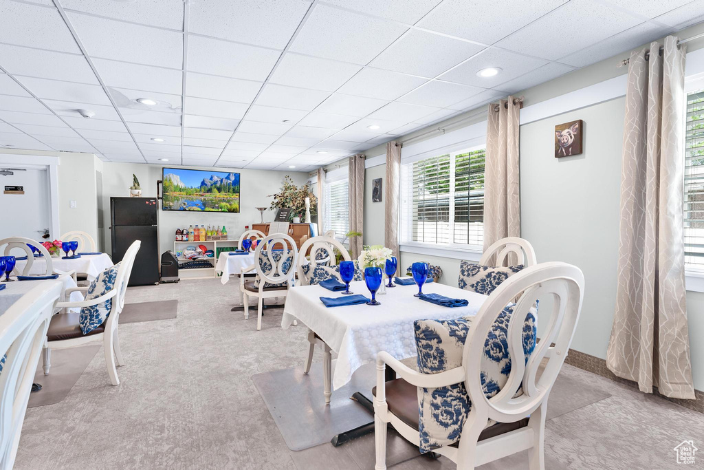 Dining space with a drop ceiling and recessed lighting