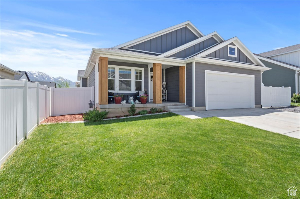View of front of house with board and batten siding, a porch, concrete driveway, and a garage