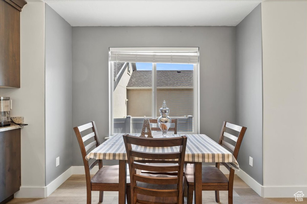 Dining area with light wood finished floors and baseboards