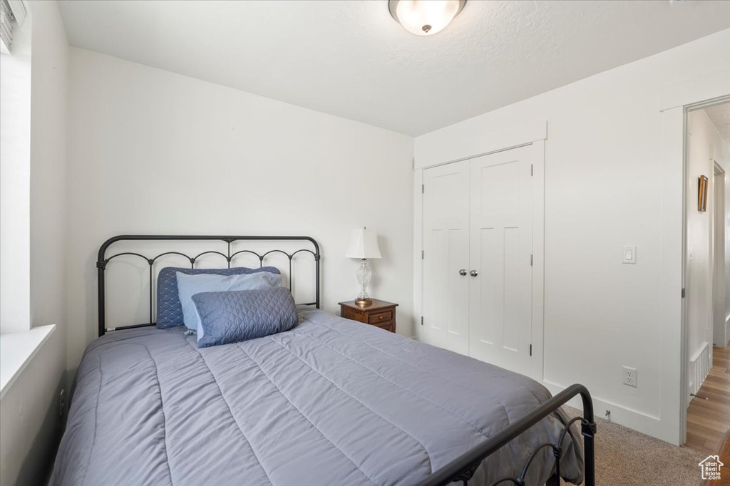 Carpeted bedroom featuring a closet