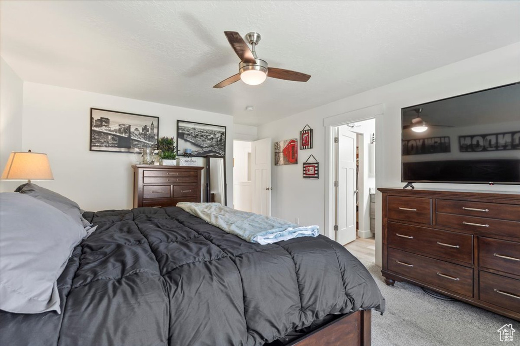 Bedroom with light colored carpet and ceiling fan