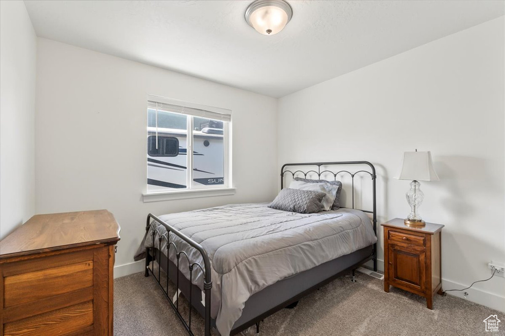 Carpeted bedroom featuring baseboards
