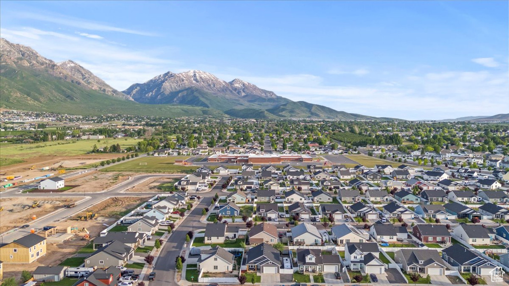 Aerial view of property's location with mountains and nearby suburban area