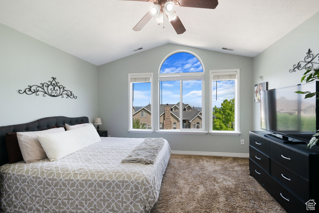 Bedroom featuring vaulted ceiling, baseboards, carpet, and ceiling fan