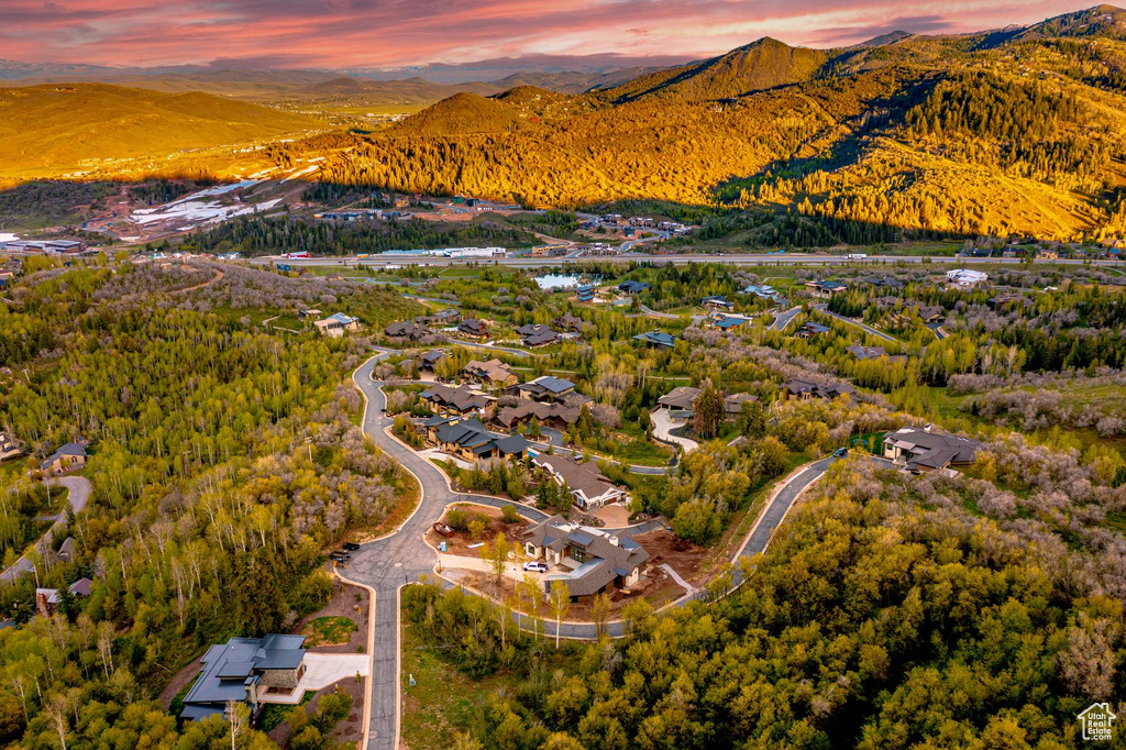Aerial view of property's location featuring a mountainous background