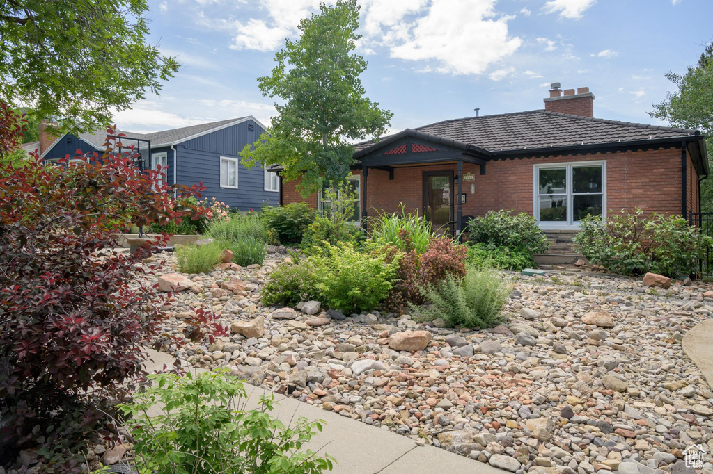 Ranch-style house with brick siding and a chimney