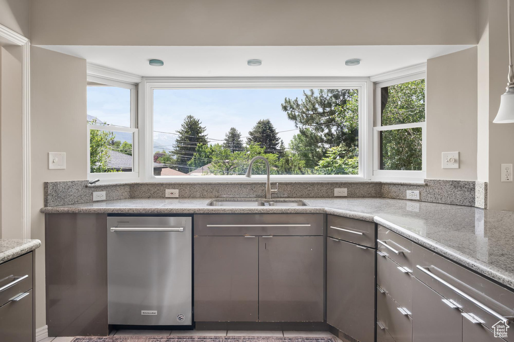 Kitchen featuring a sink, dishwasher, and gray cabinets