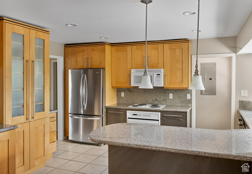 Kitchen with white appliances, electric panel, light tile patterned floors, decorative backsplash, and glass insert cabinets