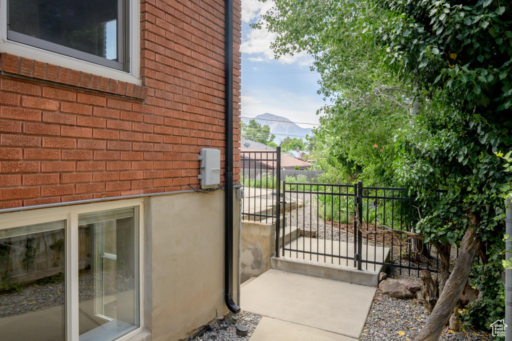 View of home\\\'s exterior with brick siding and a gate